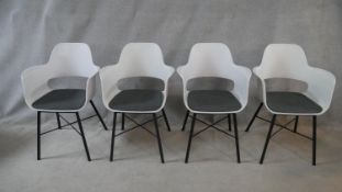 A set of four retro styled armchairs on metal supports. H.82cm