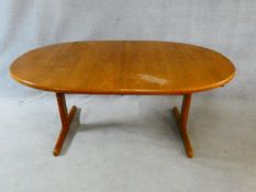 A 1960's vintage teak extending dining table on trestle style supports with extra leaf. H.72 L.167
