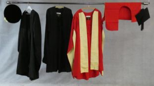 A collection of three various graduation gowns with a cap and a mortarboard, by Ede and Ravenscroft.