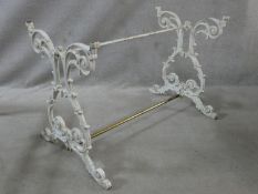 A painted cast iron table base with scrolling foliate trestle supports. H.67 L.96 W.55cm