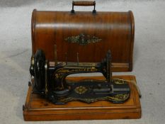 A late 19th century Singer sewing machine in fitted carrying case with original user's manual. H.