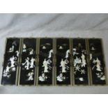 Six Japanese black lacquered mother of pearl inlaid panels with gilded painted details and floral