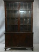 A C.1900 mahogany Georgian style bookcase with window pane glazed upper section enclosing