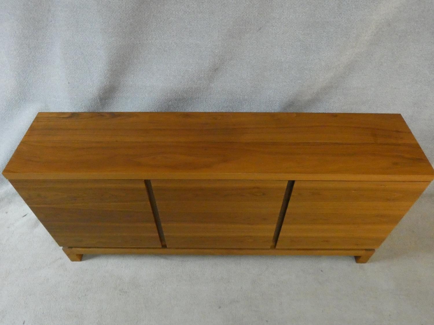 A contemporary teak sideboard with three panel doors on block feet. H.84 W.180 D.40cm - Image 3 of 4