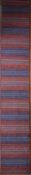 A long modern Kilim runner with bands in various hues of red and blue. L.400xW.70cm