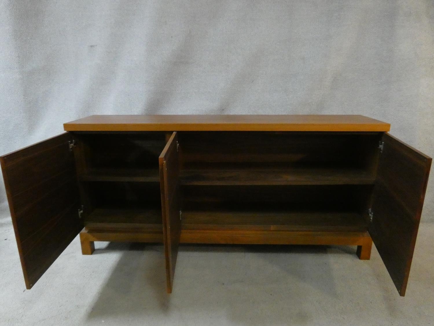 A contemporary teak sideboard with three panel doors on block feet. H.84 W.180 D.40cm - Image 2 of 4