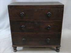 A 19th century faux mahogany painted pine chest of three drawers on turned tapering supports. H.90