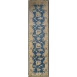 A Ziegler style runner with a palmette trellis design on an azure field within a cream floral