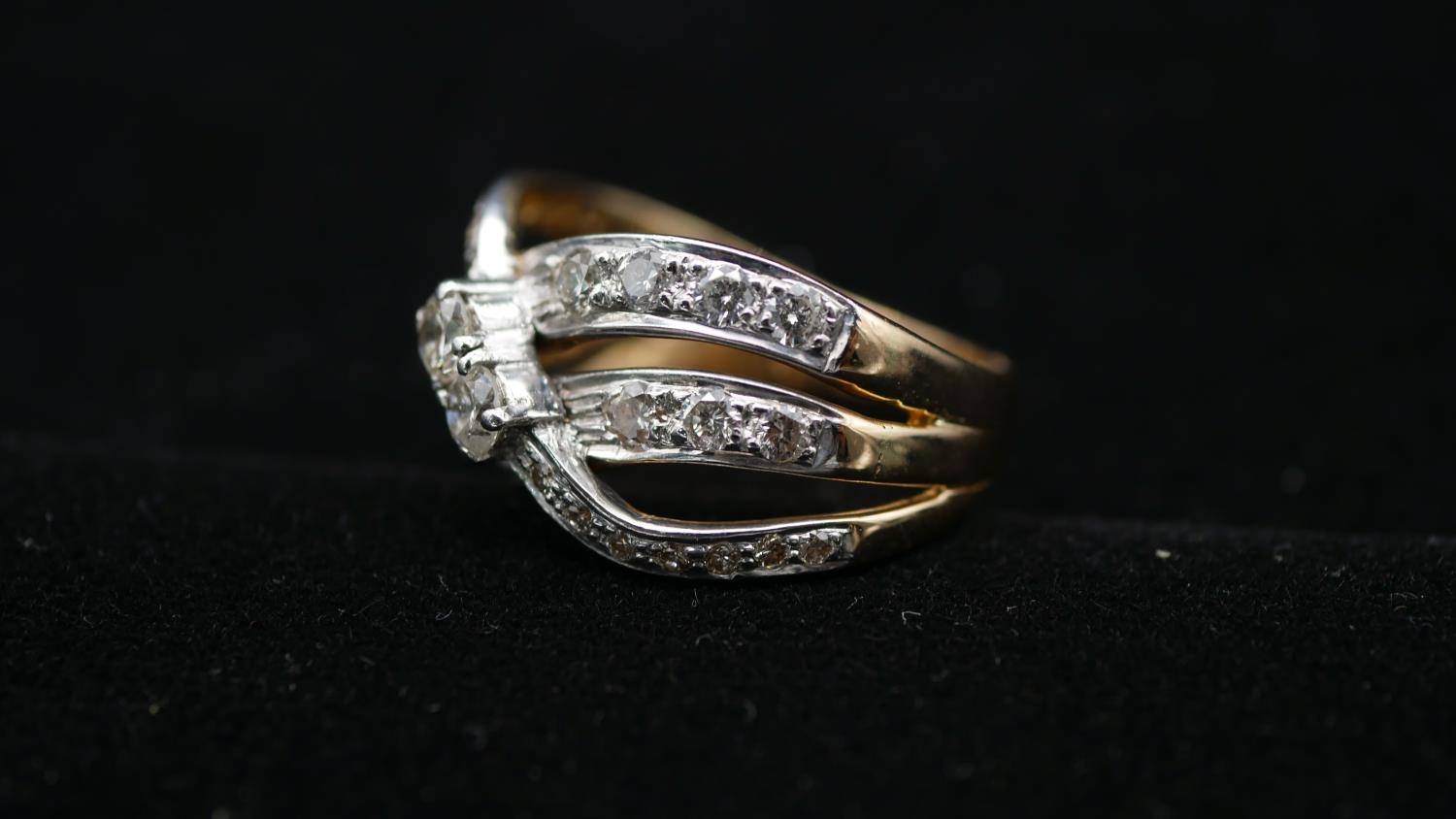An 18 carat yellow and white gold and diamond two stone cross over ring, set with a combined - Image 2 of 3