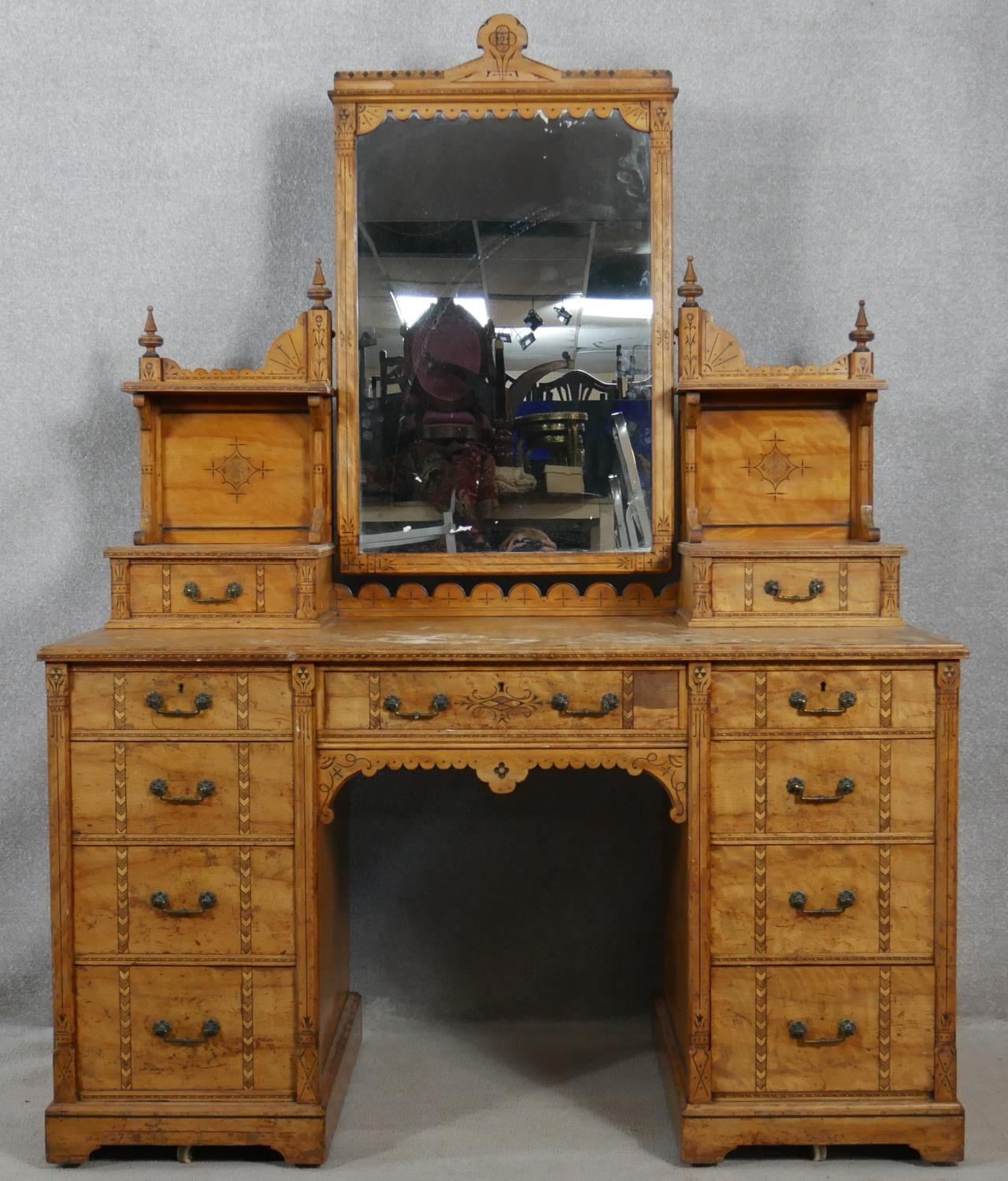 A late 19th century Aesthetic style walnut dressing table with incised carved decoration and ebony