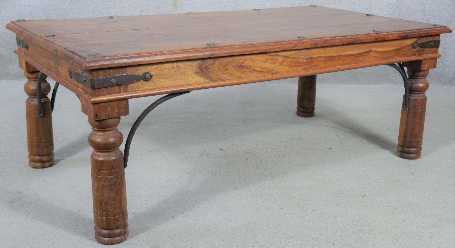 An Indian teak and metal bound coffee table on circular section supports. H.41 L.110 D.60cm - Image 2 of 4