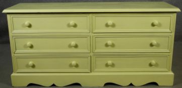 A Victorian style painted small chest of six short drawers on shaped bracket feet. H.65 W.133 D.41cm