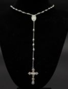 A silver oval bead chain link rosary with crucifix on the end and central medallion with the