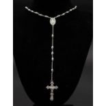 A silver oval bead chain link rosary with crucifix on the end and central medallion with the