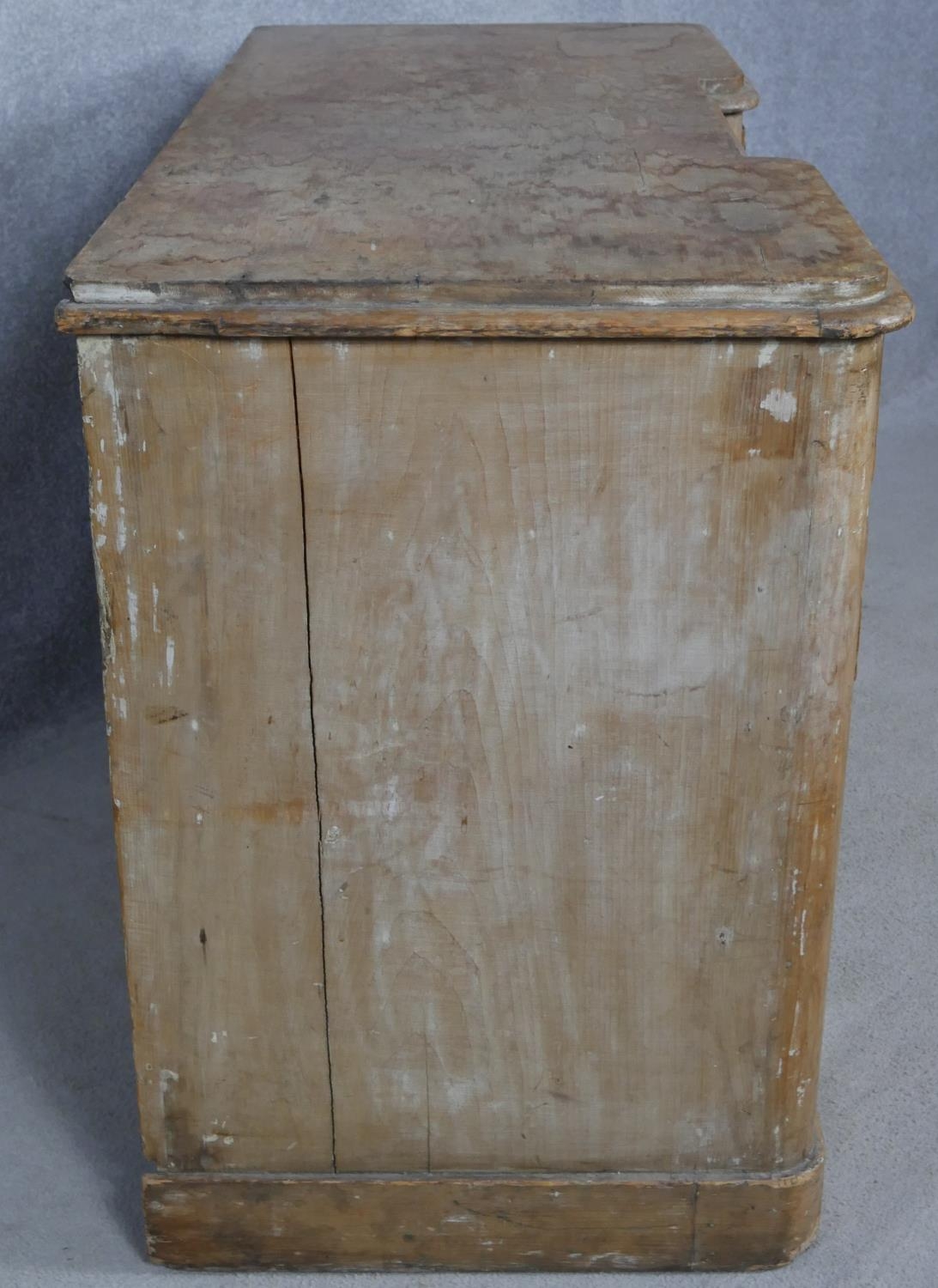 A Victorian pine kneehole desk with an arrangement of nine drawers on plinth base. H.76.5 W.120 D. - Image 6 of 9