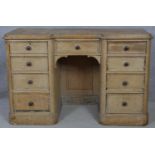 A Victorian pine kneehole desk with an arrangement of nine drawers on plinth base. H.76.5 W.120 D.