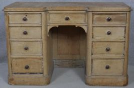 A Victorian pine kneehole desk with an arrangement of nine drawers on plinth base. H.76.5 W.120 D.