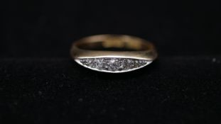 An Edwardian 18 carat yellow gold and five stone diamond ring, set to centre with 0.10 carat round