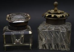 Two antique glass inkwells. One with a faceted cube design and glass top and the other with a