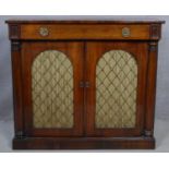 A Regency rosewood chiffonier with frieze drawer above arched metal grille doors and pleated silk