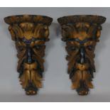 A pair of 19th century giltwood wall brackets carved with Green Man masks. H.25cm