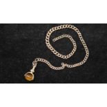 A 9ct graduated curb link 9 carat rose gold Albert chain and rolled gold swivel fob. Each link