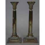 A pair of sterling silver Corinthian column candlesticks, one engraved with dedication.