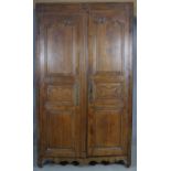 A 19th century carved chestnut French armoire. H.218 W.129 D.59cm (extensive woodworm damage and