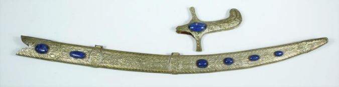 An Indian white metal foliate repousse and floral engraved sword scabbard and hilt set with Lapis