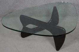 A Noguchi style coffee table with plate glass top on lacquered swivel base. H.40 L.130 W.91.5cm
