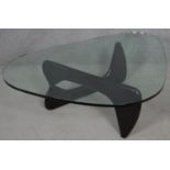 A Noguchi style coffee table with plate glass top on lacquered swivel base. H.40 L.130 W.91.5cm
