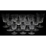 A collection of twelve glass sherry glasses with stylised foliate design and star cut bases. H.13cm