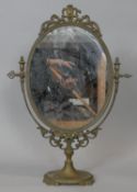 A vintage swing toilet mirror in decorative brass floral frame. H.57 W.40.5cm