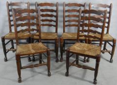 A set of six oak Lancashire ladderback dining chairs with woven rush seats on turned stretchered