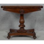 A William IV mahogany foldover top card table with baize lined surface on reeded bulbous pedestal
