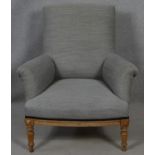 A C.1900 oak framed upholstered armchair on turned supports. H.94 W.83 D.79cm