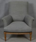 A C.1900 oak framed upholstered armchair on turned supports. H.94 W.83 D.79cm