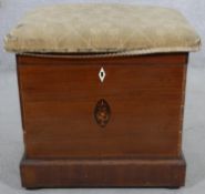 A 19th century mahogany and inlaid cellarette with twin carrying handles and upholstered top. H.50