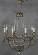 An eight branch ceiling chandelier with scrolling foliate metal frame. Dia.64cm