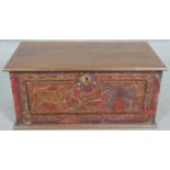 A small Eastern teak coffer with carved and painted animal decoration and twin metal carrying