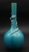 A fine turquoise glazed Chinese porcelain bottle vase with relief decoration of a dragon wrapped