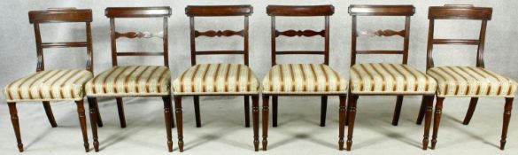 A matched set of six late Georgian mahogany dining chairs with bar backs above stuff over seats on