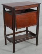 A C.1900 occasional table with fold out serving trays on square supports united by undertier. H.74