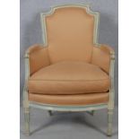 A Louis XVI style carved and painted frame fauteuil in piped damask upholstery on tapering fluted