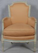 A Louis XVI style carved and painted frame fauteuil in piped damask upholstery on tapering fluted