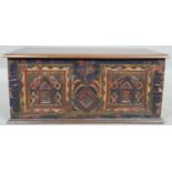 A small Eastern teak coffer with carved and painted floral decoration and twin metal carrying