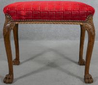 A mid Georgian style walnut stool in cut moquette upholstery on carved cabriole supports on hairy