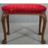 A mid Georgian style walnut stool in cut moquette upholstery on carved cabriole supports on hairy