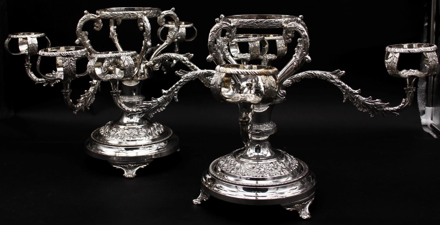 A pair of silver plated four branch centre pieces with scrolling foliate and floral motifs. Stamps