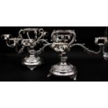 A pair of silver plated four branch centre pieces with scrolling foliate and floral motifs. Stamps